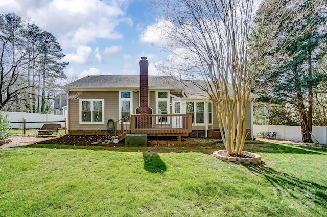 back of house featuring a lawn, a deck, a fenced backyard, crawl space, and a chimney