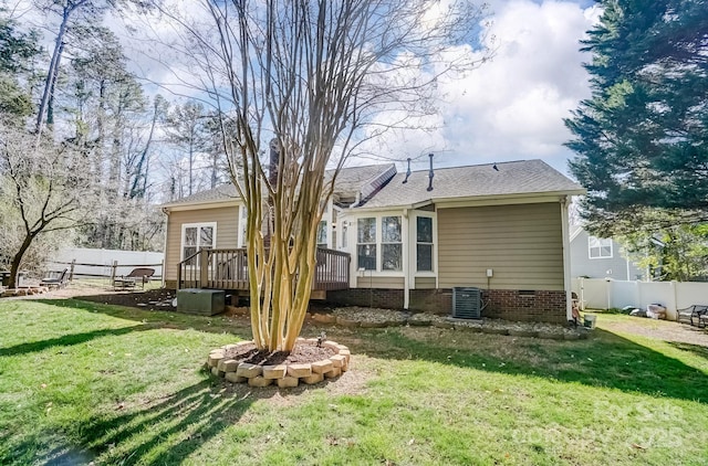 rear view of property with a deck, fence, a yard, cooling unit, and crawl space