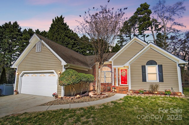 ranch-style home with fence, driveway, a yard, a garage, and brick siding