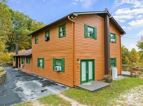 rear view of house featuring cooling unit