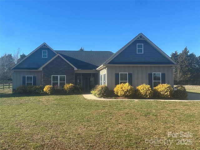 craftsman-style house featuring board and batten siding and a front yard