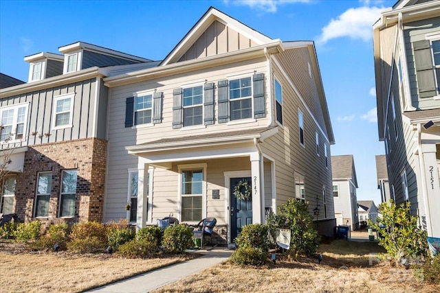 multi unit property featuring a porch and board and batten siding