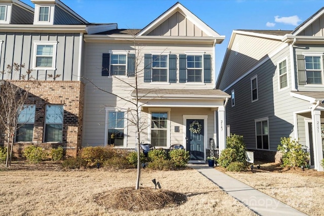 view of front of house featuring brick siding and board and batten siding