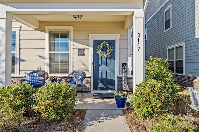 entrance to property featuring covered porch