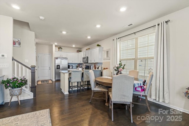 dining area with baseboards, visible vents, dark wood finished floors, stairway, and recessed lighting