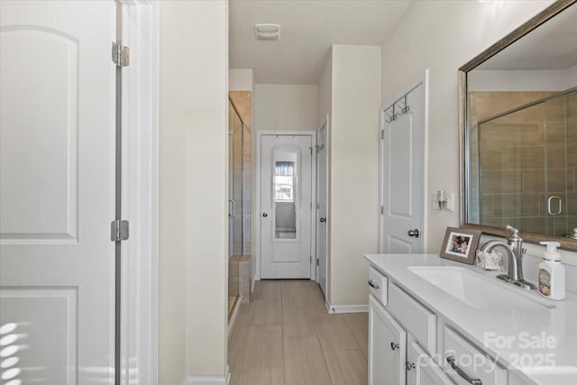 bathroom with a stall shower and vanity