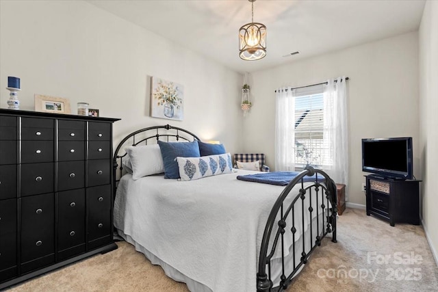 bedroom featuring light carpet, baseboards, visible vents, and a notable chandelier