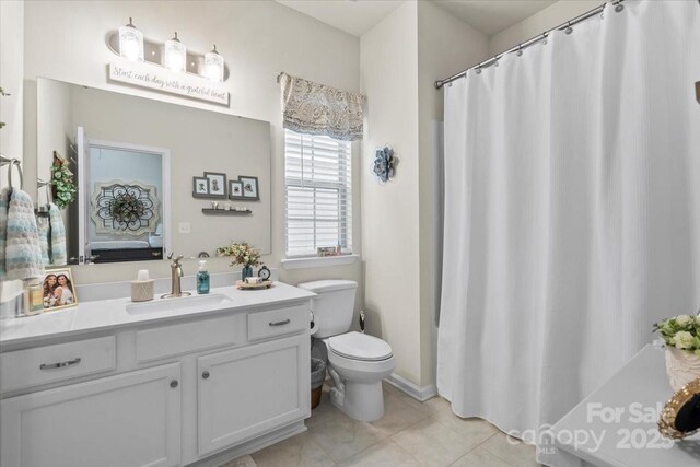 full bath with a shower with curtain, vanity, toilet, and tile patterned floors