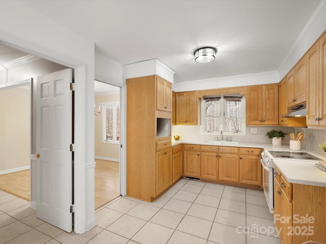 kitchen featuring light tile patterned floors, white electric stove, a sink, light countertops, and under cabinet range hood