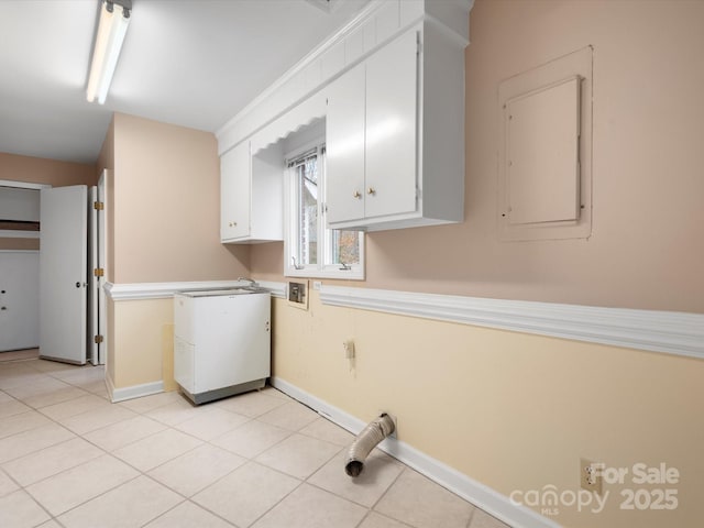 laundry room with electric panel, cabinet space, light tile patterned floors, baseboards, and hookup for a washing machine