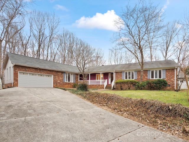 ranch-style house featuring brick siding, a porch, an attached garage, and driveway