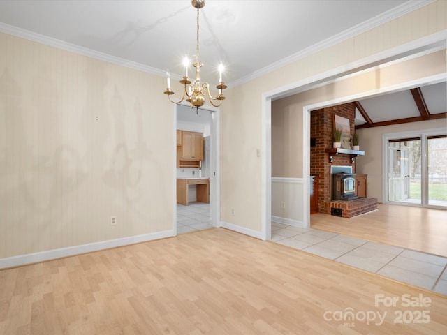 unfurnished living room featuring lofted ceiling, ornamental molding, light wood-style floors, baseboards, and a chandelier