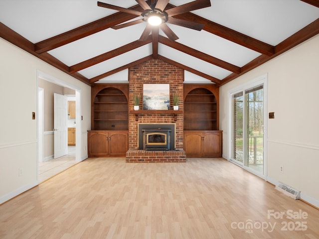 unfurnished living room featuring lofted ceiling with beams, visible vents, built in shelves, and light wood-style flooring