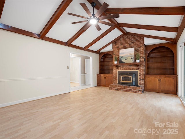 unfurnished living room featuring built in shelves, wood finished floors, baseboards, and vaulted ceiling with beams