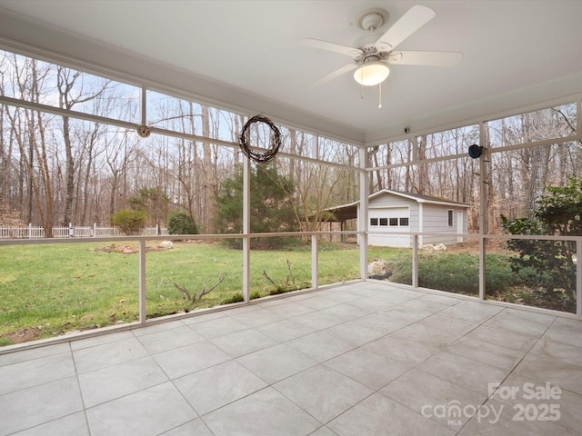 unfurnished sunroom with a ceiling fan