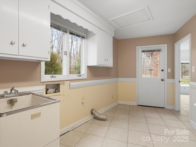 kitchen featuring white cabinetry, light countertops, light tile patterned floors, and baseboards