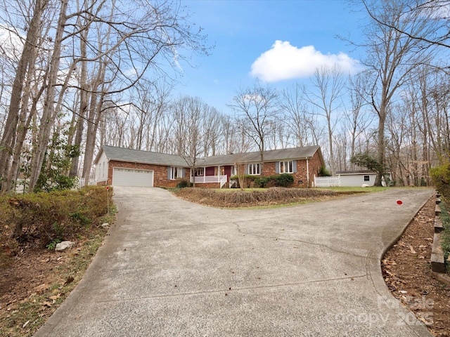 ranch-style home with brick siding, concrete driveway, and an attached garage