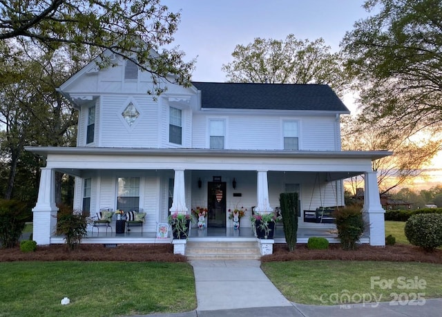 view of front of house featuring covered porch and a front yard