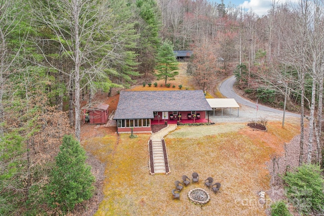 birds eye view of property with a wooded view