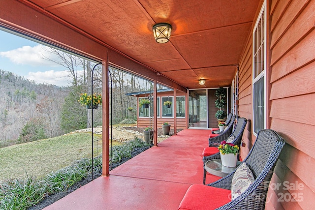 view of patio / terrace with a view of trees