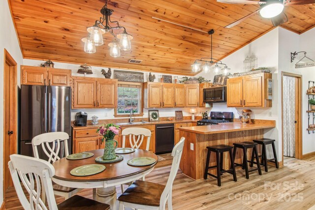 kitchen featuring stove, light wood-style floors, freestanding refrigerator, wood ceiling, and dishwasher