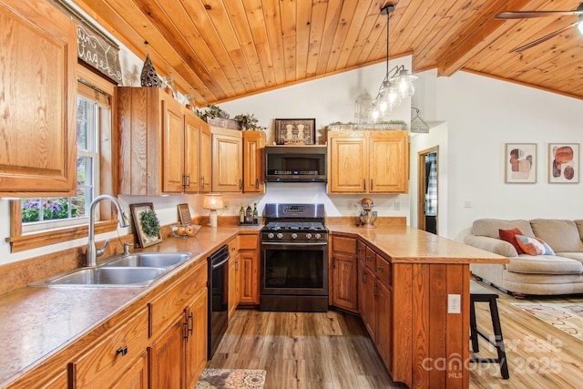 kitchen featuring a breakfast bar area, stainless steel appliances, a peninsula, a sink, and wood ceiling