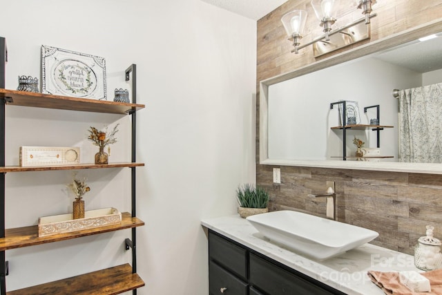 bathroom with tasteful backsplash and vanity