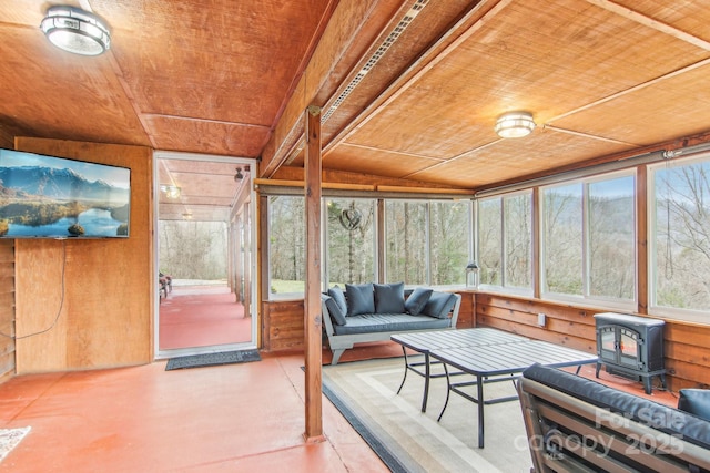 sunroom with a wood stove and wood ceiling