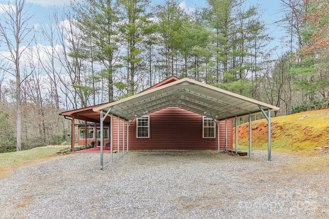 view of outdoor structure featuring driveway and a carport