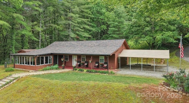 211 Heartland Rdg, Sylva, NC 28779 - view of front of house featuring driveway, a front yard, a porch, a forest view, and a sunroom