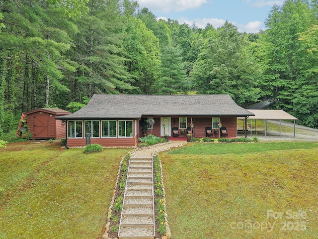 211 Heartland Rdg, Sylva, NC 28779 - view of front of home featuring a detached carport, a porch, a front yard, and a storage unit