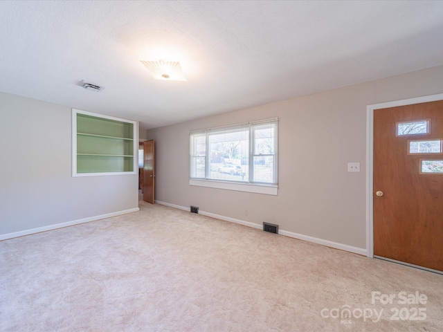 spare room with visible vents and baseboards