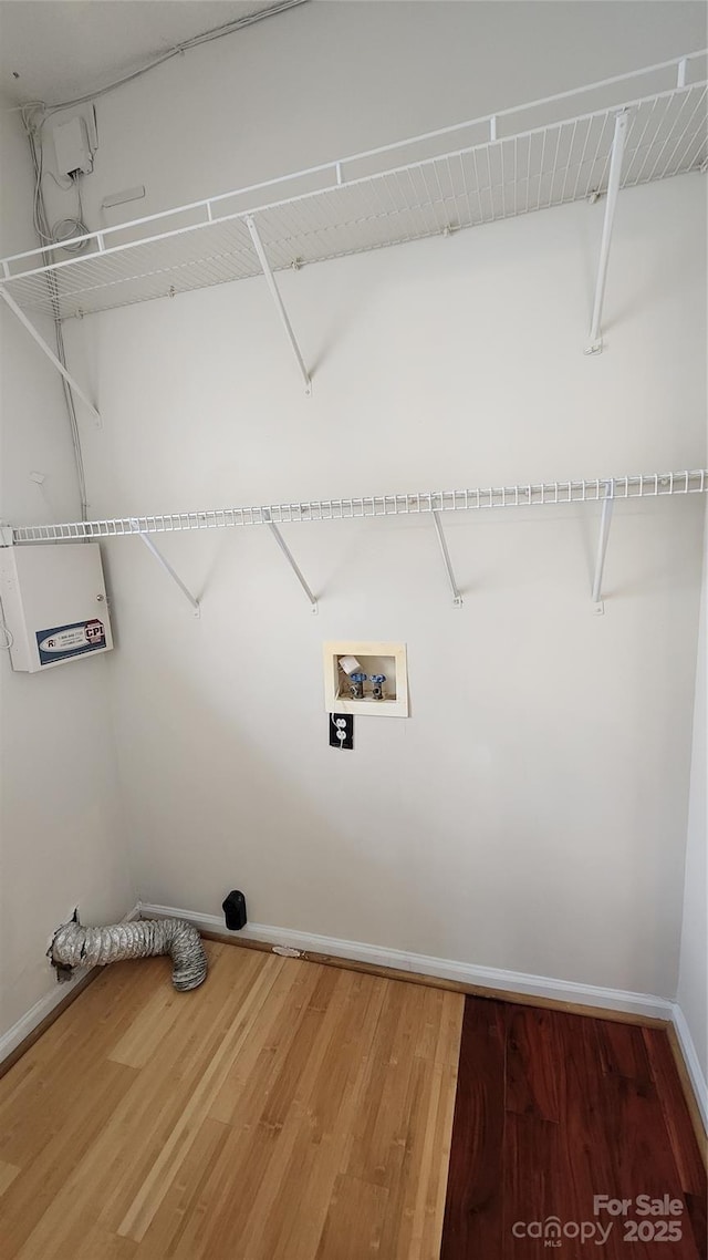 washroom with laundry area, washer hookup, wood finished floors, and baseboards