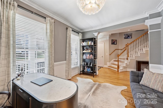 office area with baseboards, ornamental molding, wood finished floors, and ornate columns