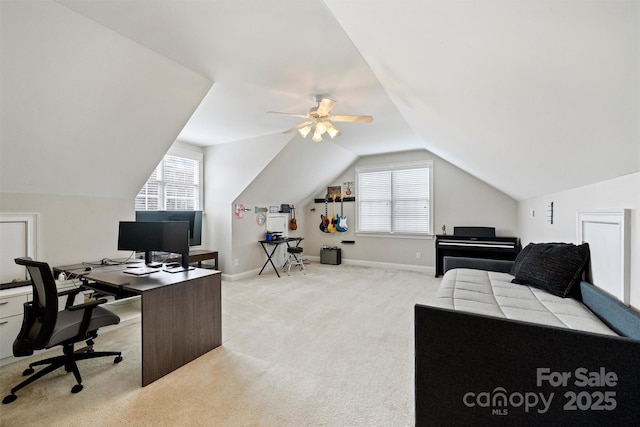 office space with baseboards, vaulted ceiling, and light colored carpet