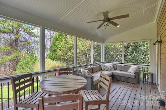 sunroom / solarium with lofted ceiling, wooden ceiling, ceiling fan, and a wealth of natural light