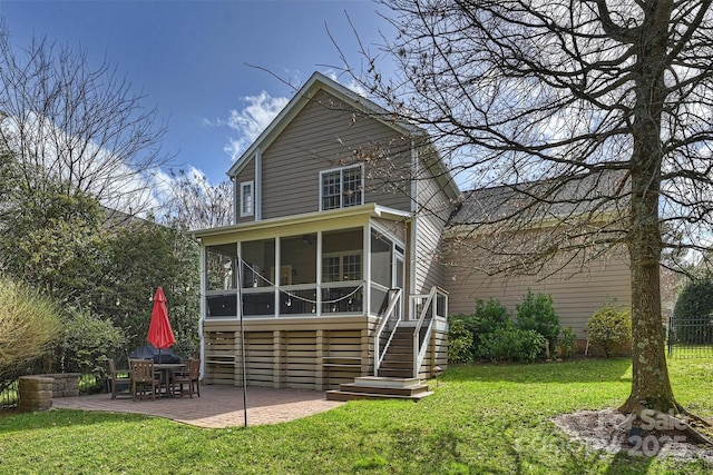 back of property with a patio, a sunroom, stairs, fence, and a yard