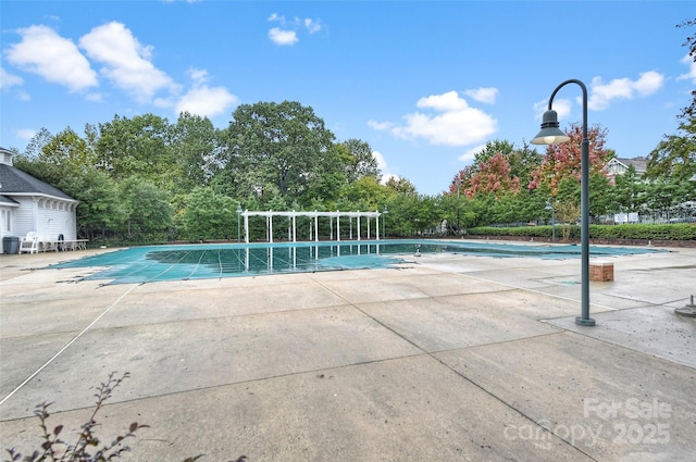 community pool with a patio area
