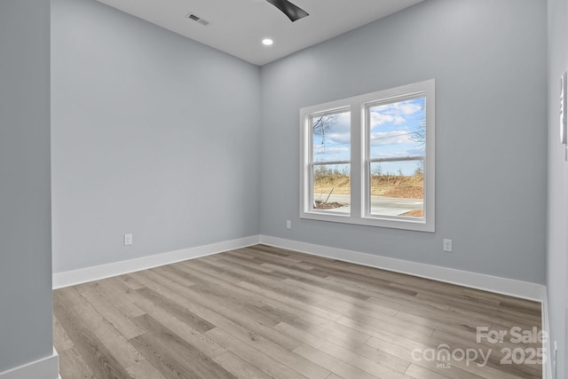 unfurnished room with ceiling fan, recessed lighting, wood finished floors, visible vents, and baseboards