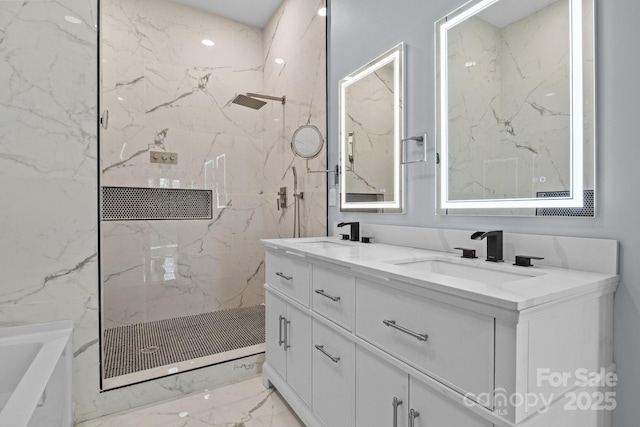 full bathroom featuring marble finish floor, a marble finish shower, and a sink