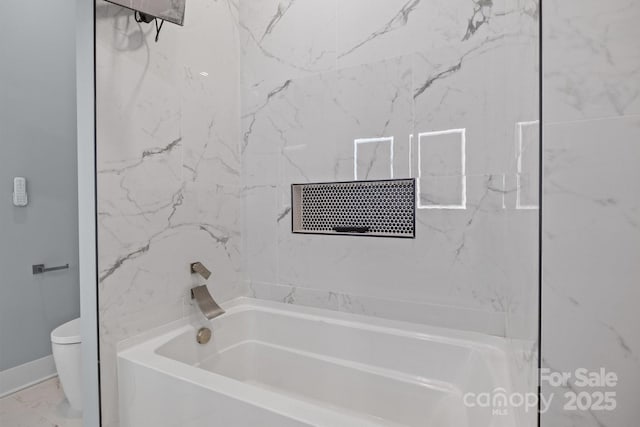 bathroom with washtub / shower combination, marble finish floor, and toilet