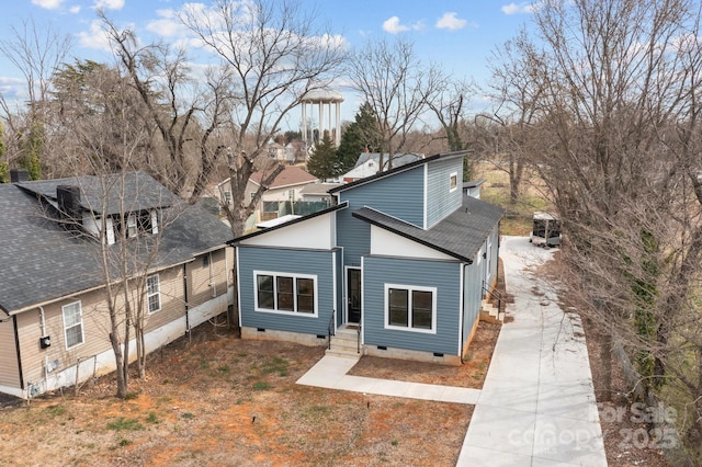 view of front of property featuring crawl space and a shingled roof