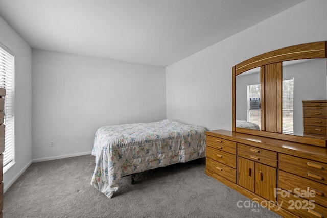 carpeted bedroom featuring baseboards