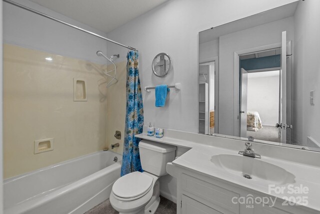 full bathroom with vanity, shower / bath combo with shower curtain, and toilet