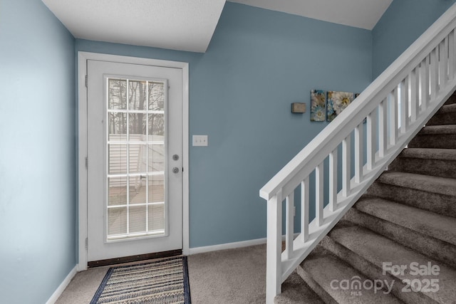 doorway to outside with carpet floors, stairway, and baseboards