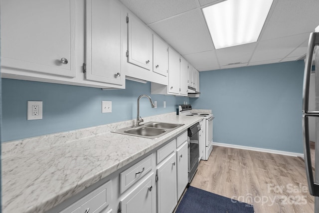 kitchen featuring dishwasher, electric stove, light countertops, and a sink