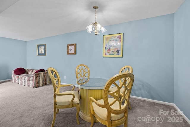 dining room with carpet, baseboards, and an inviting chandelier