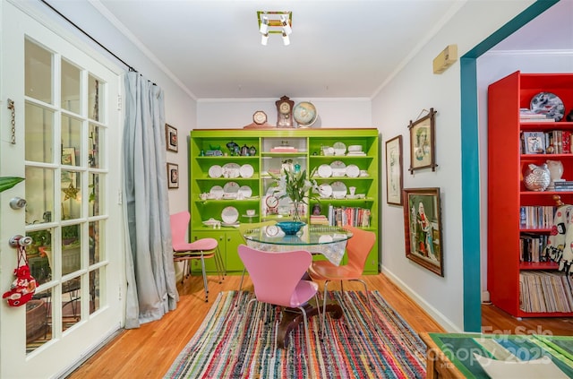 dining space featuring crown molding and wood finished floors