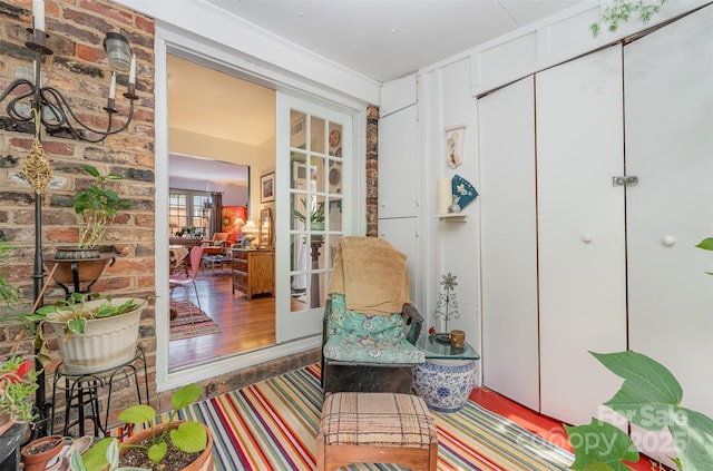 living area with french doors and wood finished floors