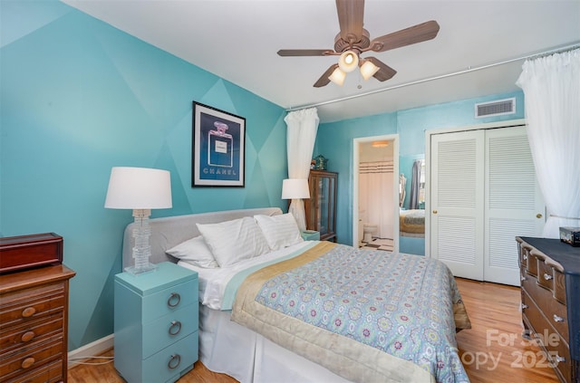 bedroom featuring a ceiling fan, light wood-type flooring, a closet, and visible vents